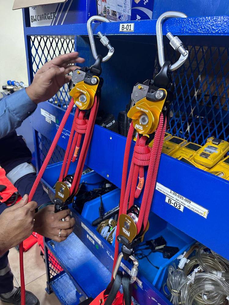 Petzl twin-release haul systems rigged with red rope in front of an equipment store